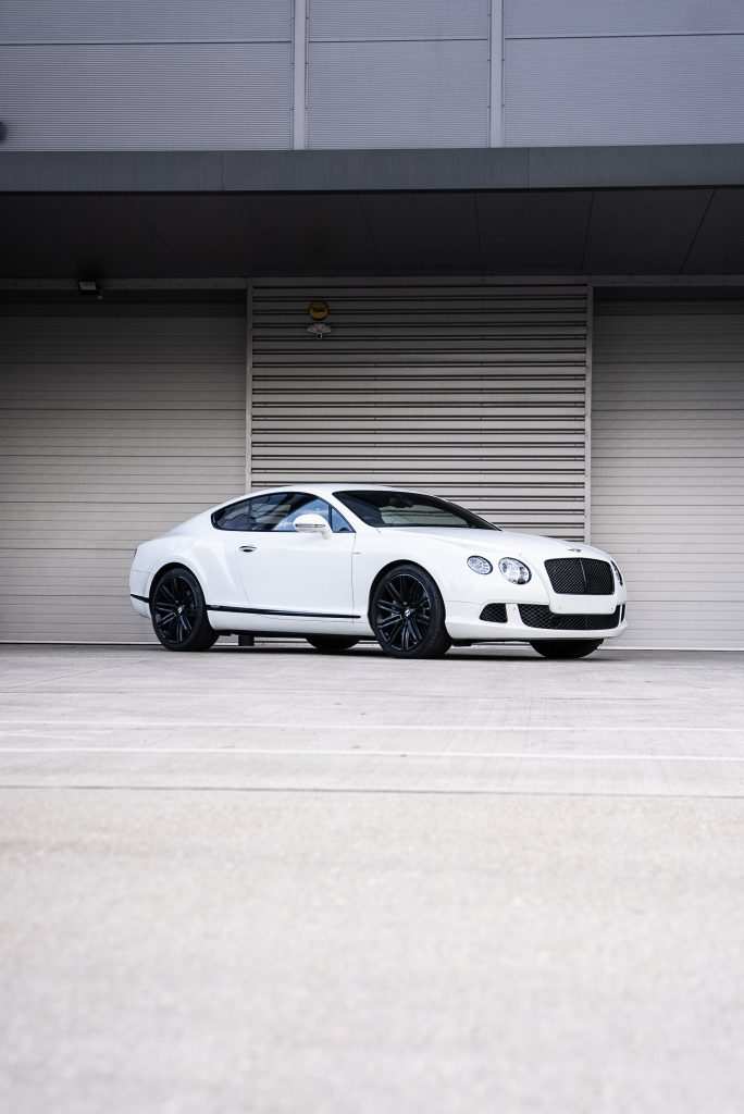 Bentley continental parked in front of garage