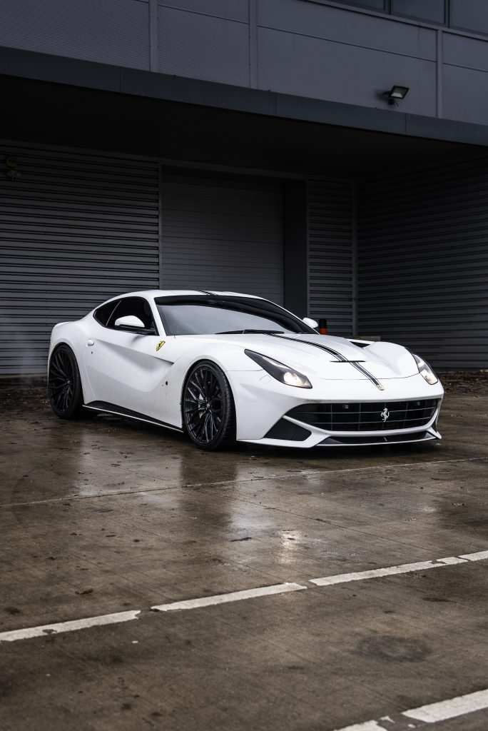 Ferrari f12 parked in front of garage